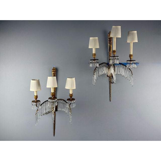 Maison Jansen, Hollywood Regency, Feather Form Wall Sconces or Wall Lights, Crystal, Bronze, France, 1940s A stunning pair...