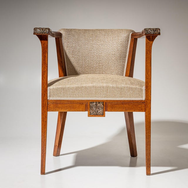 Pair of Italian Art Nouveau armchairs featuring rounded backrests and straight armrests terminating in finely detailed...