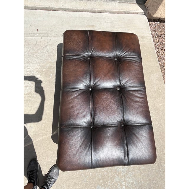High Quality Tufted Leather Style Chesterfield Ottoman with Tack Trim and Turned Feet. I believe it is a Bernhardt Colston...