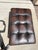 High Quality Tufted Leather Style Chesterfield Ottoman with Tack Trim and Turned Feet. I believe it is a Bernhardt Colston...