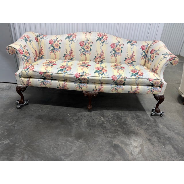 Bring timeless elegance to your space with this beautifully crafted vintage camelback sofa, featuring classic Chippendale-...