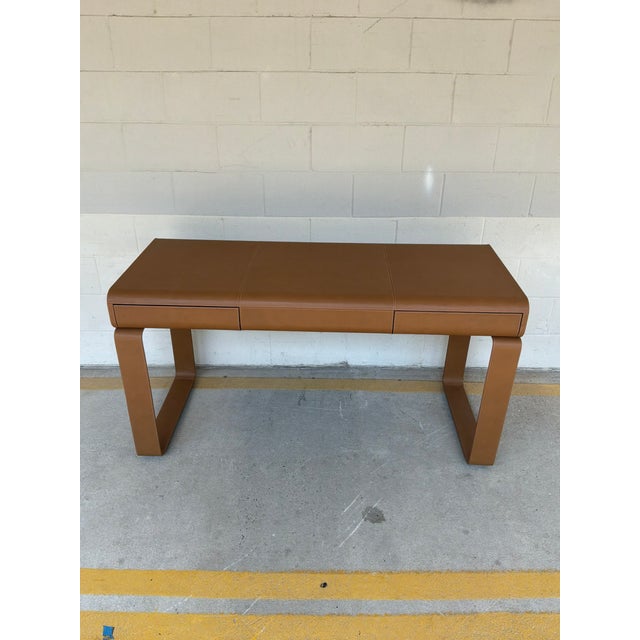 Sleek Arteriors Meyer Leather Desk, warm cognac finish. Clean architectural legs. Original Retail $5825. Showroom floor...