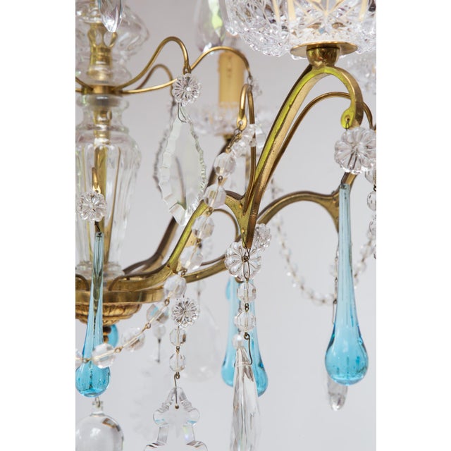 It uses 6 E14 bulbs, not included. 61 cm in diameter. It hangs 85 cm from the wall using the chain shown in the photos....