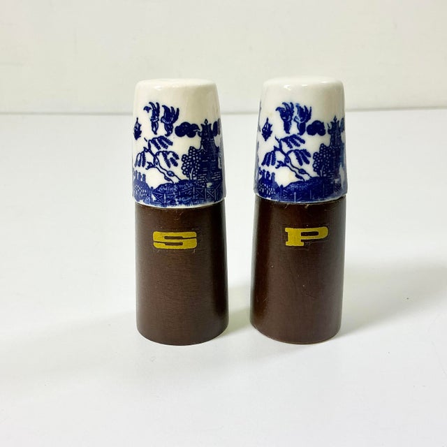 A pair of vintage Salt & Pepper Shakers from the 1950s featuring a Blue Willow ceramic top. The bottoms are walnut. Both...