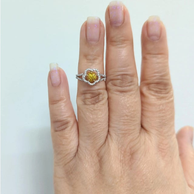 Beautiful 0.88 ct. bright yellow sapphire round with 0.21 ct. good quality white diamond rounds. Handmade in 18k yellow...