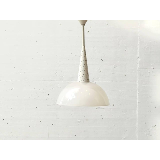 This exceptional pendant lamp by mathieu matégot, created in collaboration with the renowned glass manufacturer holophane,...