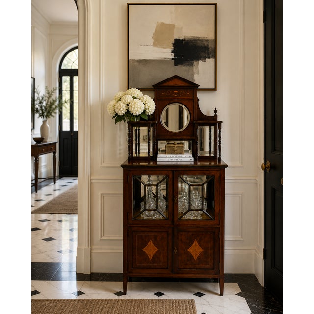 A particularly elegant antique Edwardian mahogany display cabinet retaining its original mirrored superstructure and...