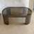 Karl Springer "Banker" low table in a gunmetal finish. Solid brass trim on interior under smoked glass. Unsigned. Shown in...