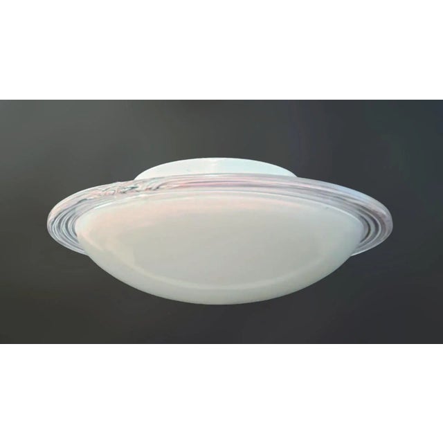 Vintage Italian flush mount or wall light with a single milky white Murano glass shade enclosed in clear border with thin...
