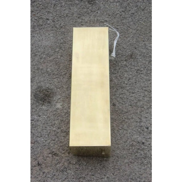 This Minimalist sconce in brass and Acrylic Glass was produced in Italy during the 1950s. Inside are two port light bulbs:...