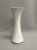 A white German porcelain vase with gold trim and curved lines.. Manufactured by Hutscheneruther, the tall vase has an...