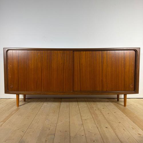 This teak sideboard with sliding doors is an authentic example of scandinavian mid-century modern design dating back to...