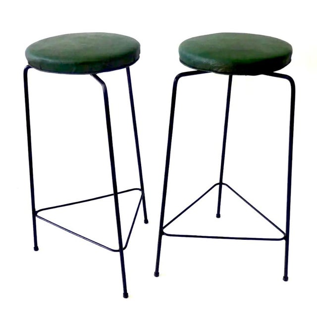 This set of vintage Mid-Century Modern bar stools captures the perfect essence of mid-century industrial charm. Attributed...