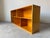 A beautifully crafted vintage bookcase constructed from solid birch wood, showcasing the natural golden tone and swirling...