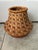 This handmade clay and wicker pot from Ghana features a bulbous terracotta base wrapped with tightly woven natural fibers...