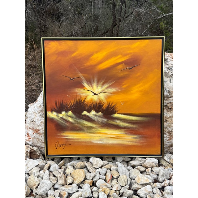 Vintage mid-century modern framed oil painting on canvas. Art depicts seagulls in flight at sunset over a coastal...
