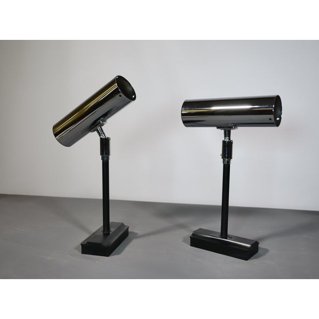 Two minimalist space-age wall lamps by Staff, Germany, 1970s. Chrome-plated wall lamps with a clean, geometric design and...