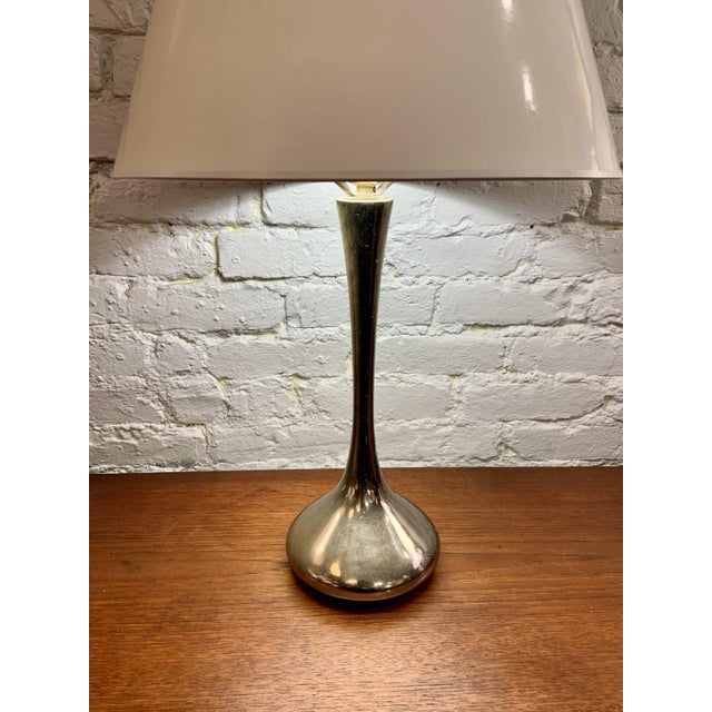 Elegant vintage accent table lamp manufactured by Laurel Lamp Company. The lamp features a sculptural polished-chrome base...