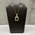 This designer Effy pendant necklace is crafted in 14kt yellow gold and showcases a stunning 1.42 carat emerald cut green...