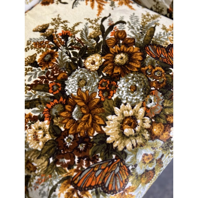 Beautiful vintage floral upholstered chair with butterfly accents.