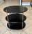1960's oval English Campaign style 3-tier dark wood side table or etagere, with decorative brass supports and finial...