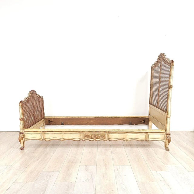 A Belle Époque painted and gilt French Louis XV–style bed, circa 1890. Inside measurements 35.75" w x 74" d.
