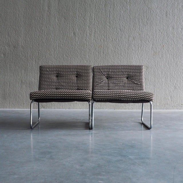 This pair of mid-century modular lounge chairs features a rich brown and off-white woven geometric pattern, set against...
