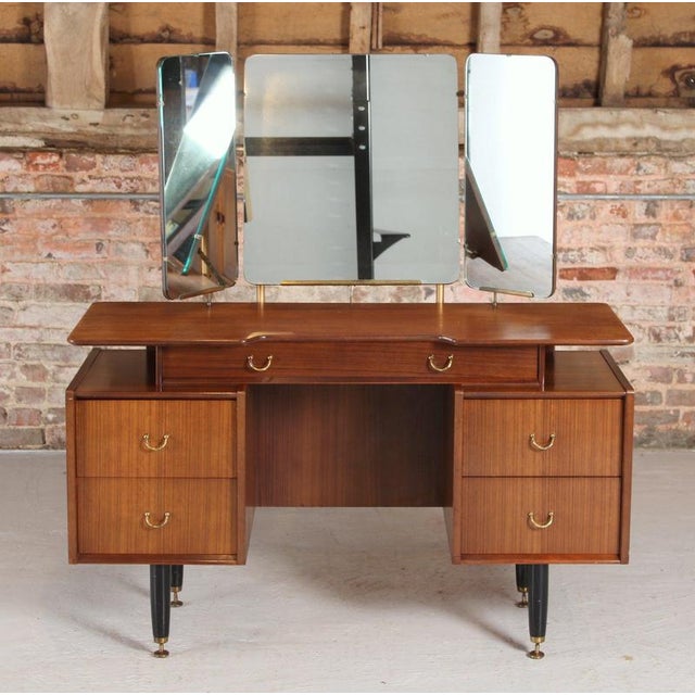 Mid Century G-plan Librenza tola and black dressing table, circa 1960s. Five drawers with brass handles and 3 mirrors....