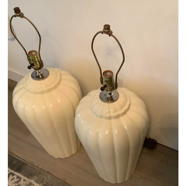 Elegant pair of Midcentury Cream ceramic jar form table lamps, circa 1960s. lamps are wired with brass fittings. Shades...