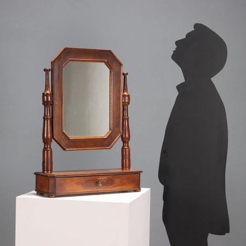 A walnut freestanding psyche. Tilting mirror supported by a pair of turned columns resting on a base with a small drawer...