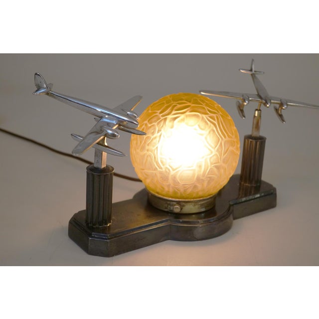 A stunning and insanely rare Art Deco Streamline era Aviation Award twin Chrome Airplane table "Brain Globe" lamp circa...