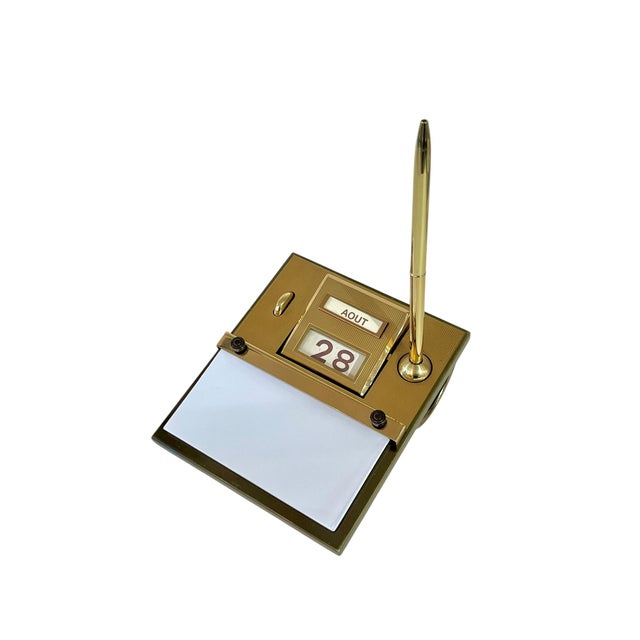 Vintage French mid century modern perpetual calendar with contemporary pen and new notepad. Turn the dial and the number...