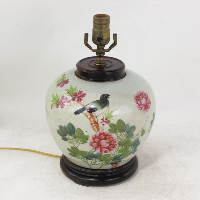This antique table lamp is repurposed from an authentic white porcelain vase decorated in a vibrant Famille Rose palette....