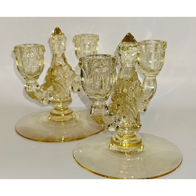 Stunning candle holders made by the Heisey Glass Company, known for its elegant glass production. The specific pattern is...