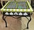 Fun and creative, a 1970-80s paint decorated beveled glass top caned and wrought metal end or side table, one drawer...