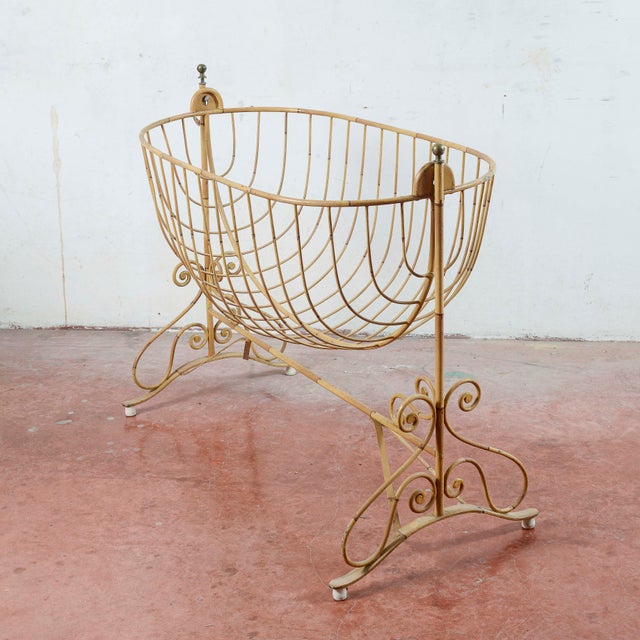 This charming vintage wrought iron crib, dating back to the first half of the 20th century, is an antique piece with an...