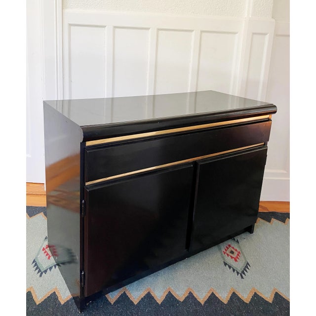 Cool 1970s modern Broyhill solid wood black lacquer sideboard with brass accents. Felt-lined top drawer. Dimensions: 40"...