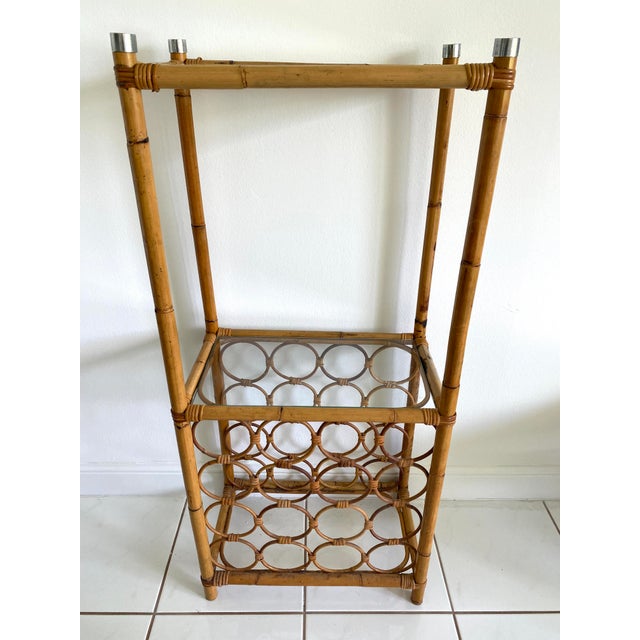 Rattan Two Tier Shelving unit with lower wine rack thar hold 16 bottles. Two glass shelves measure 17x9.5 Space between...