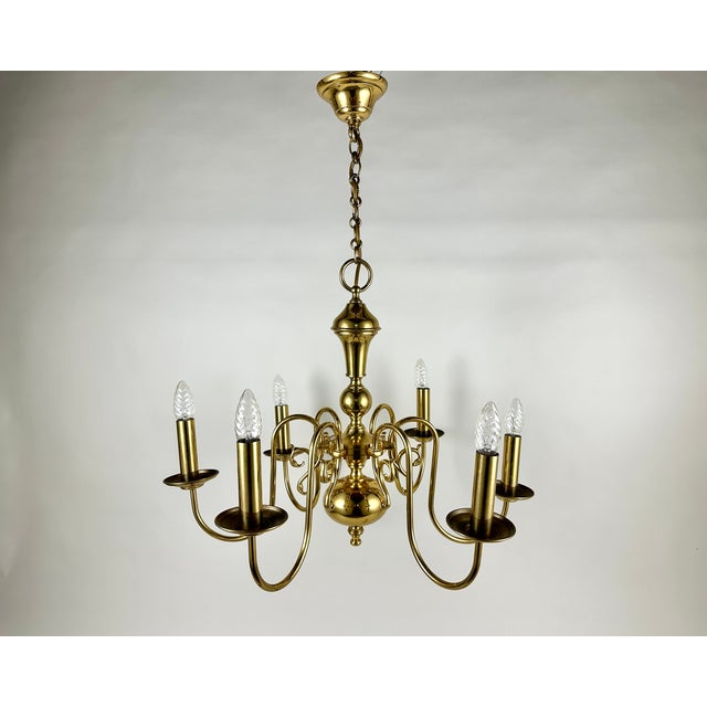 Elevate your interior with this stunning vintage brass chandelier, a true masterpiece of Belgian craftsmanship from the...