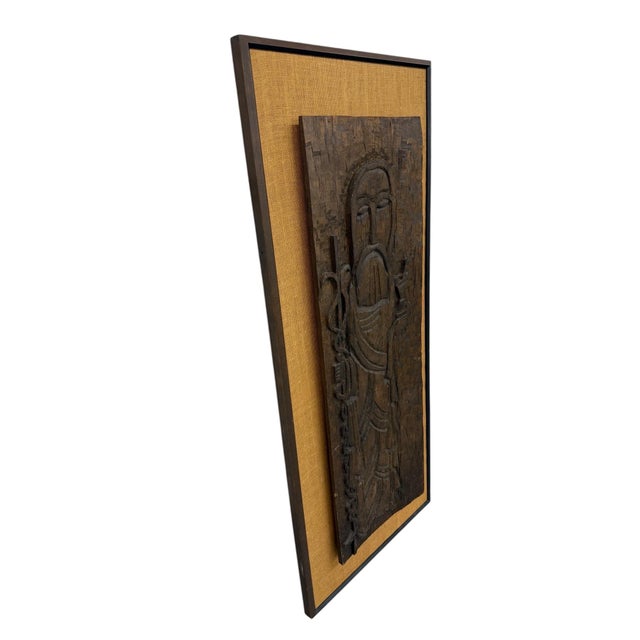 Striking 1960s hand-carved wood wall hanging depicting a stylized figure most likely representing Jesus, with a serene...