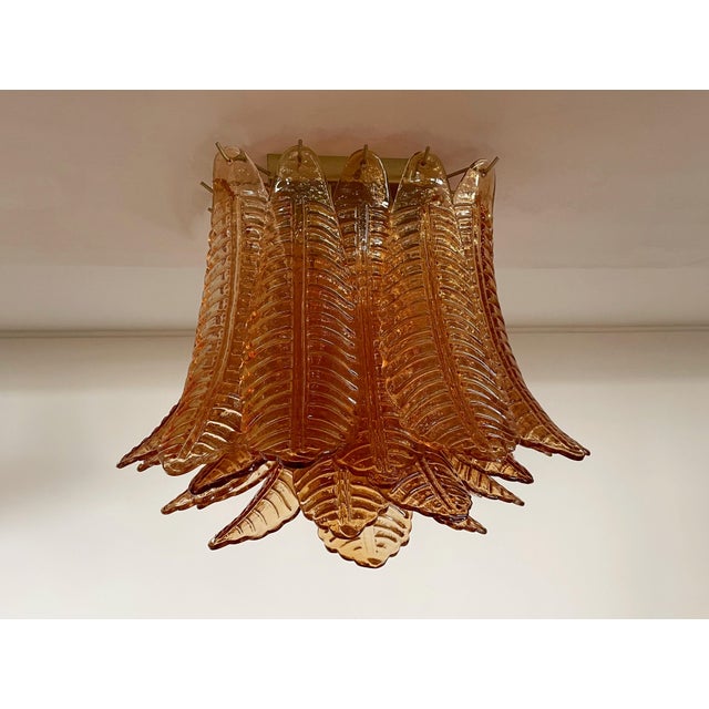 Spectacular ceiling lamp with 32 Murano ameber leaves in golden painted metal frame. Elegant lighting object. Period: late...