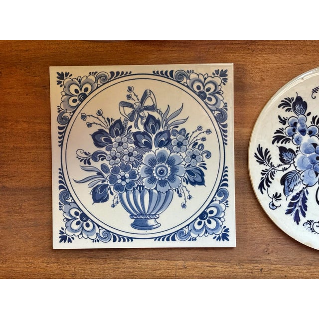 A pair of charming Delft floral tile trivets, one round and one square. Would also be lovely hanging on the wall. I ship...