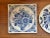 A pair of charming Delft floral tile trivets, one round and one square. Would also be lovely hanging on the wall. I ship...