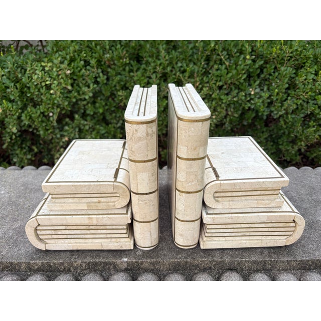 Pair Of Maitland Smith Tessellated Travertine And Brass Bookends. We offer a rare pair of Post-Modern tessellated...
