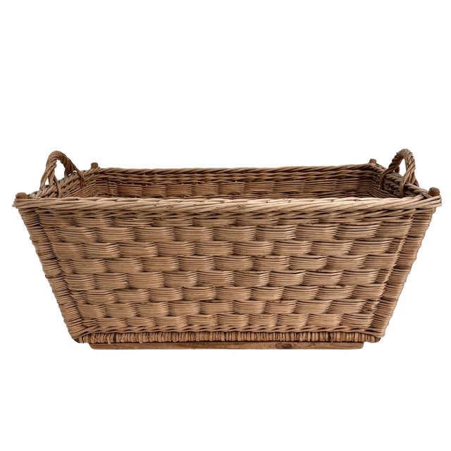 Traditional extra large 1960s woven wicker French market basket with braided handles Two wood supports on the bottom...