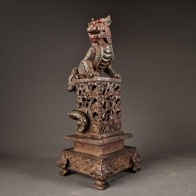 This is an impressive antique bronze incense burner featuring a finely detailed Qilin, a mythical hooved creature revered...