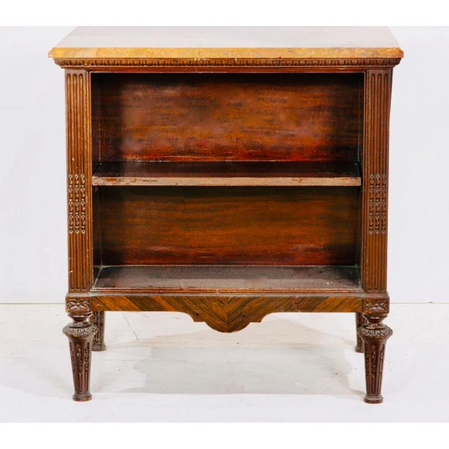 A Neoclassical style marble top bookstand, circa 1900, the open case with two tiers and rising on metal mounted fluted...