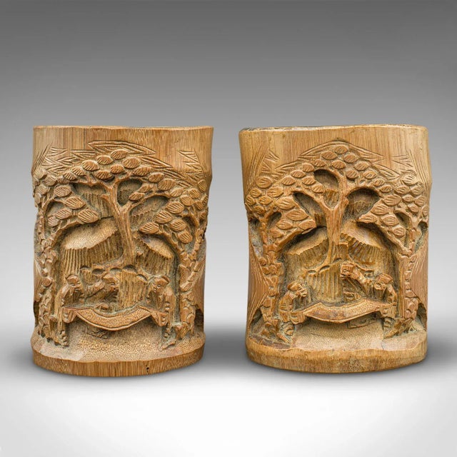 This is a pair of vintage brush pots. A Chinese, hand-carved bamboo dry flower vase, dating to the early 20th century,...