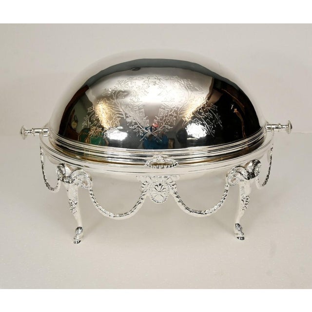 A highly decorative silver plated entre or chafing dish in the edwardian style, of classic oval form with a revolving...