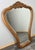 A beautifully crafted Vintage French oak mirror featuring an elegant carved frame with flowing curves and a decorative...